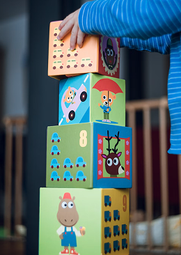 Child stacking colorful toy blocks